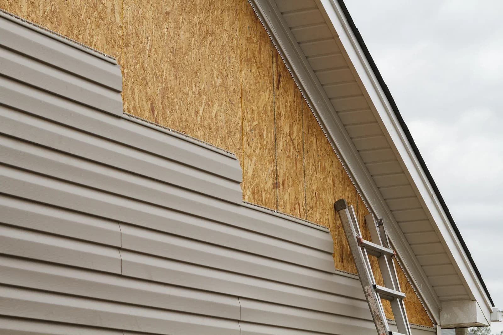 Siding installation in progress with part of the wall sheathing visible